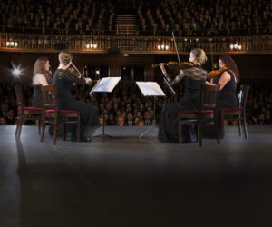 Quartet performing on stage in theater